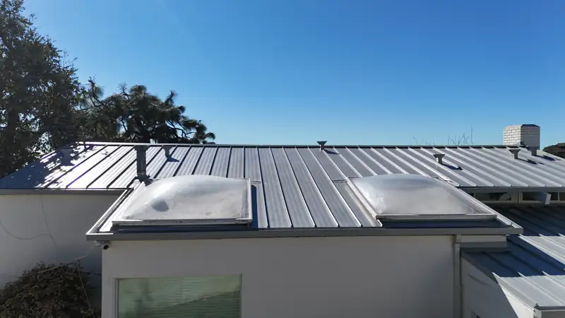 Finished light gray standing seam roof with skylights on a Los Angeles hillside house