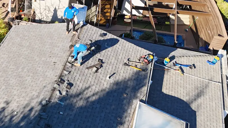 Crew tearing off old shingles down to the deck on a Los Angeles hillside house